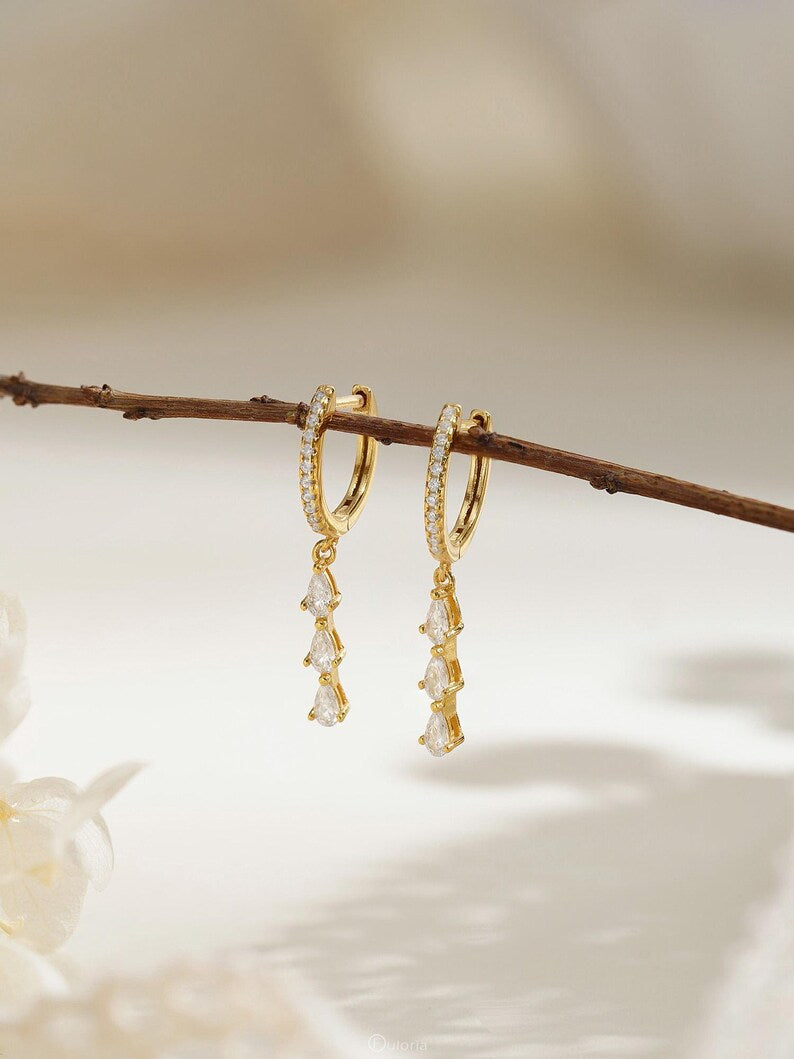 Exquisite diamond hoop earrings featuring tassels and crystal pendants; crafted from 18K gold and 925 sterling silver