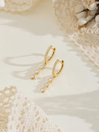 Exquisite diamond hoop earrings featuring tassels and crystal pendants; crafted from 18K gold and 925 sterling silver
