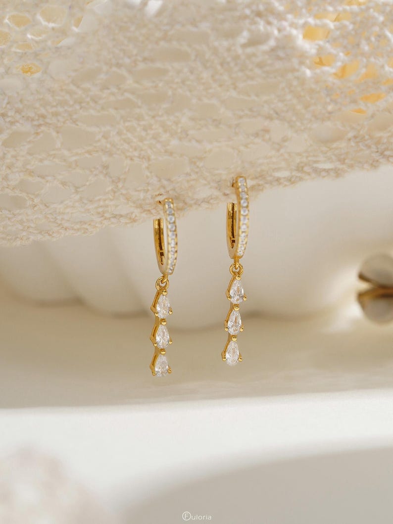 Exquisite diamond hoop earrings featuring tassels and crystal pendants; crafted from 18K gold and 925 sterling silver