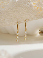 Exquisite diamond hoop earrings featuring tassels and crystal pendants; crafted from 18K gold and 925 sterling silver