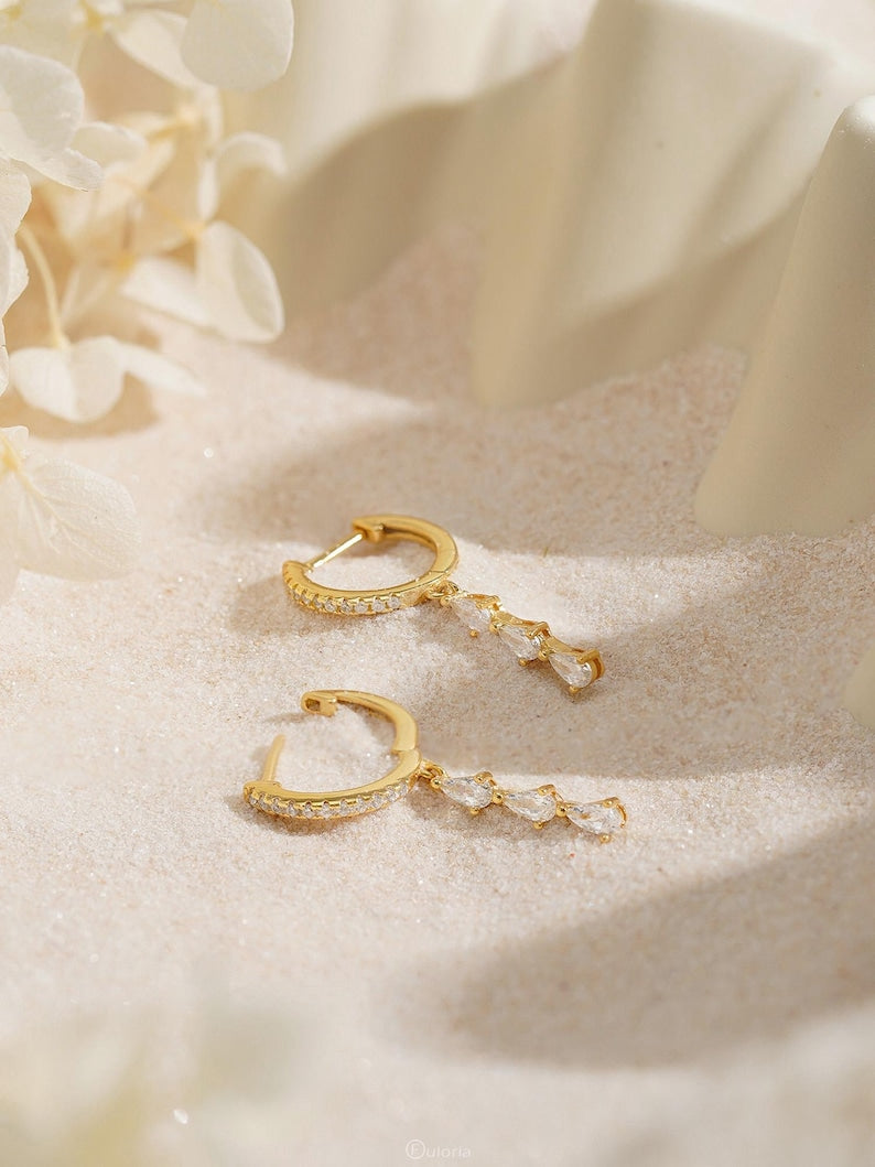 Exquisite diamond hoop earrings featuring tassels and crystal pendants; crafted from 18K gold and 925 sterling silver