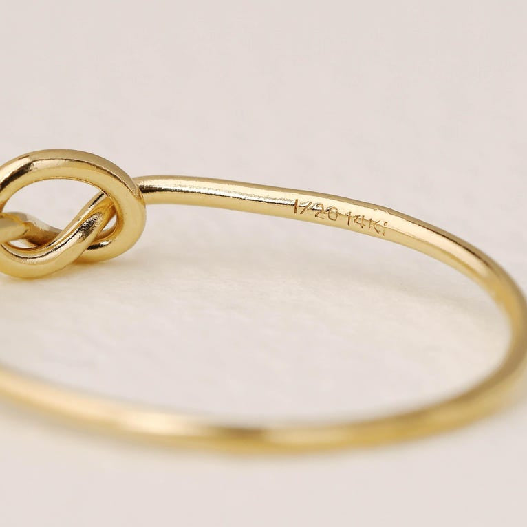 14K gold-plated knot ring—a delicate, minimalist piece perfect for stacking; band width: 1mm