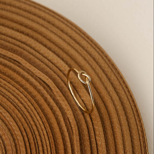 14K gold-plated knot ring—a delicate, minimalist piece perfect for stacking; band width: 1mm