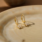 Gold flower-motif hoop earrings, delicate clip-style drop earrings