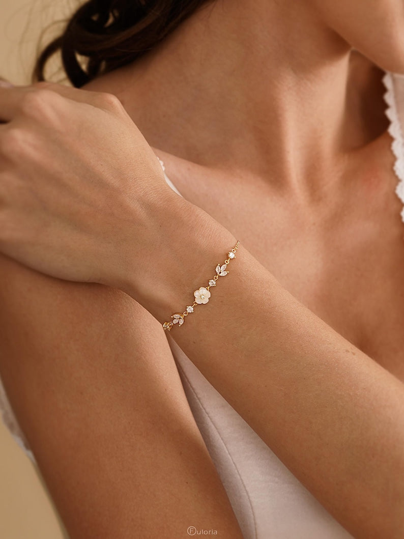 Exquisite floral diamond bracelet, accented with mother-of-pearl and crystal leaves; available in gold or silver; adjustable length (16 + 3 cm)