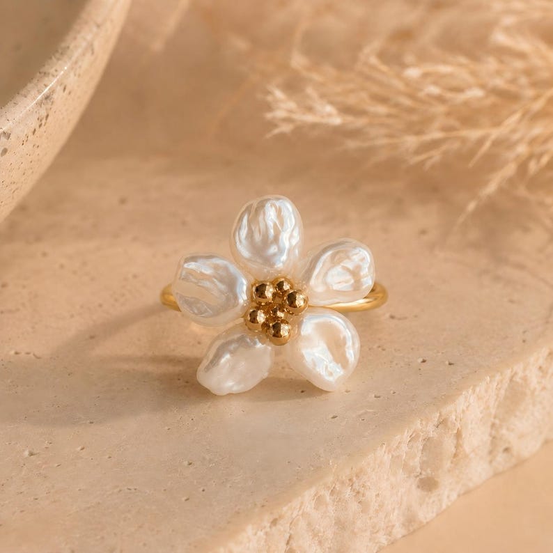 Gold-tone adjustable open ring, adorned with five faux Baroque pearl petals
