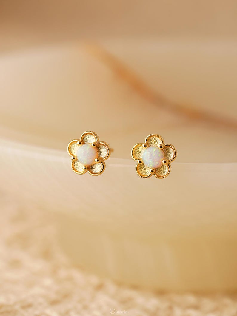 Floral opal stud earrings, available in 18K gold or 925 sterling silver, featuring white opals in a minimalist floral design