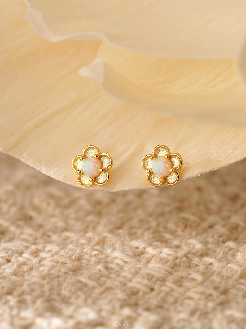 Floral opal stud earrings, available in 18K gold or 925 sterling silver, featuring white opals in a minimalist floral design
